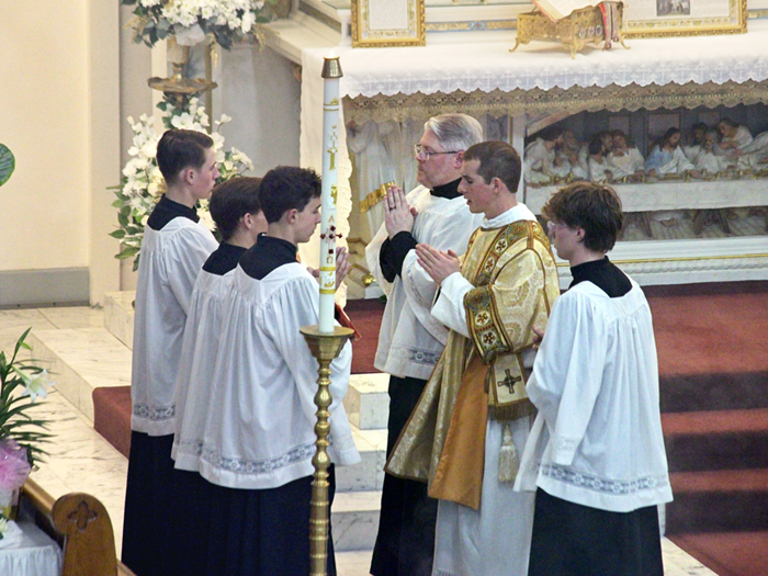 Rev. Anthony Alley chants the Gospel during the Easter Midnight Mass.